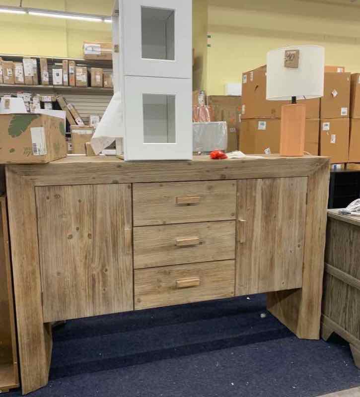Wooden sideboard with table lamp on top